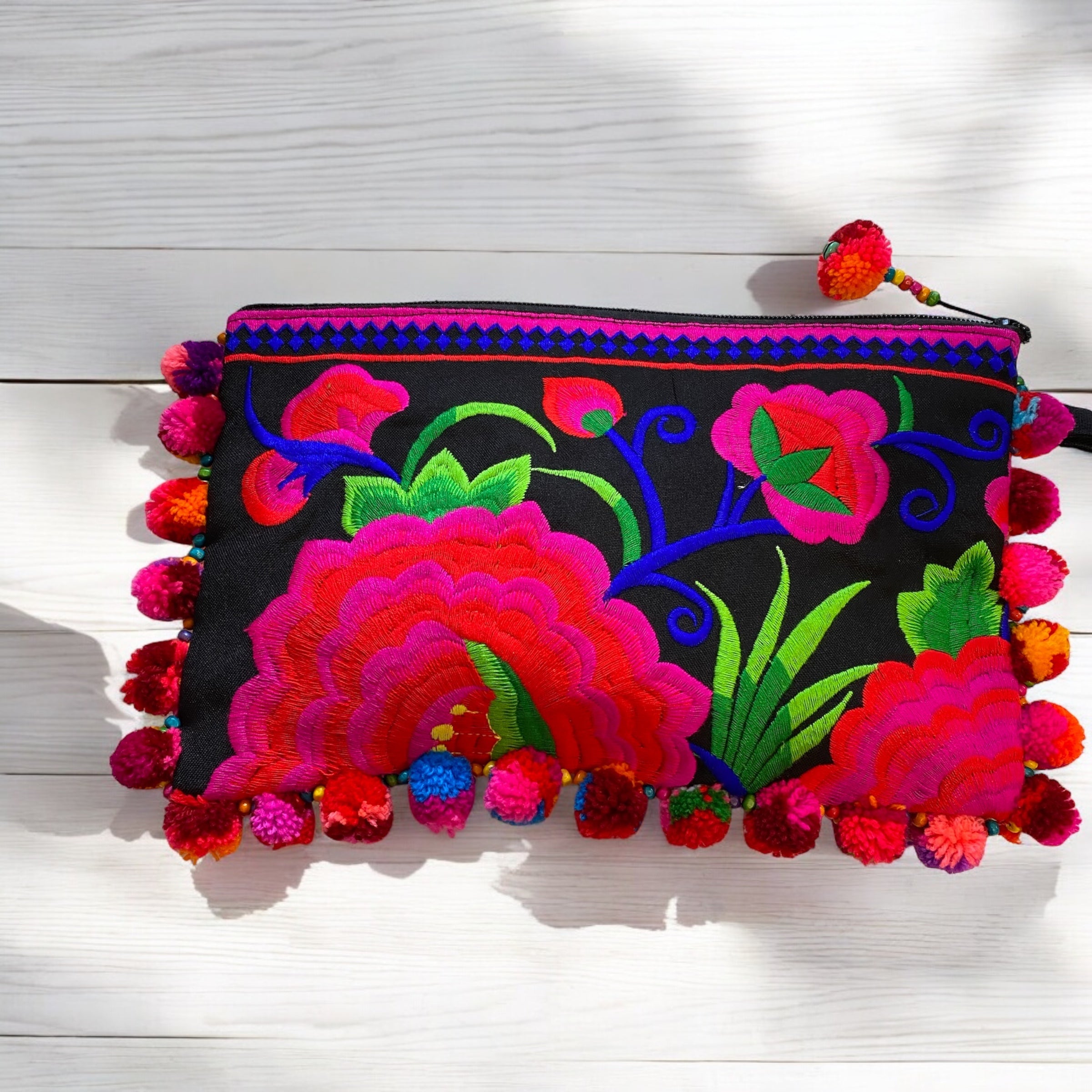 Hot pink and cherry red blossom on licorice with multi coloured pom pom clutch