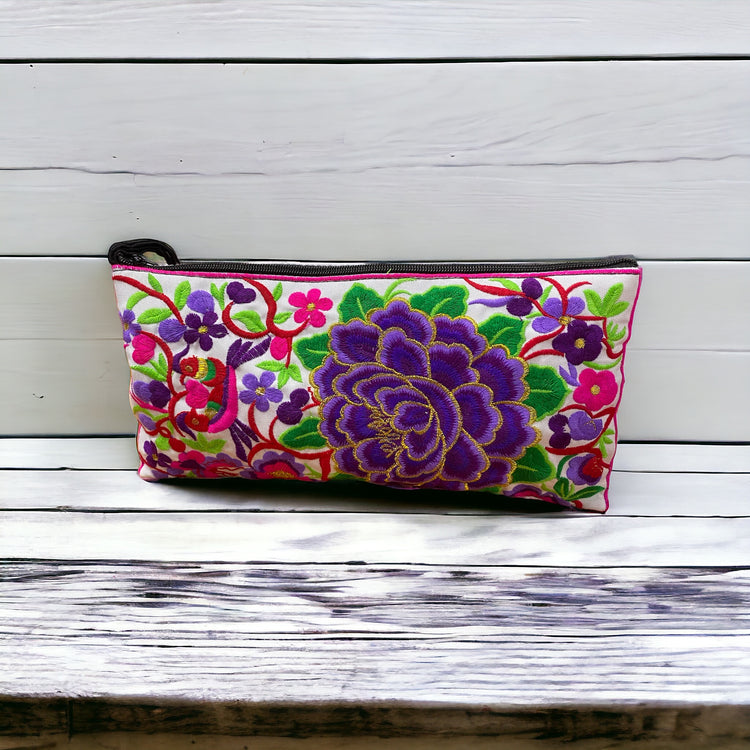 Violet blossom on white clutch