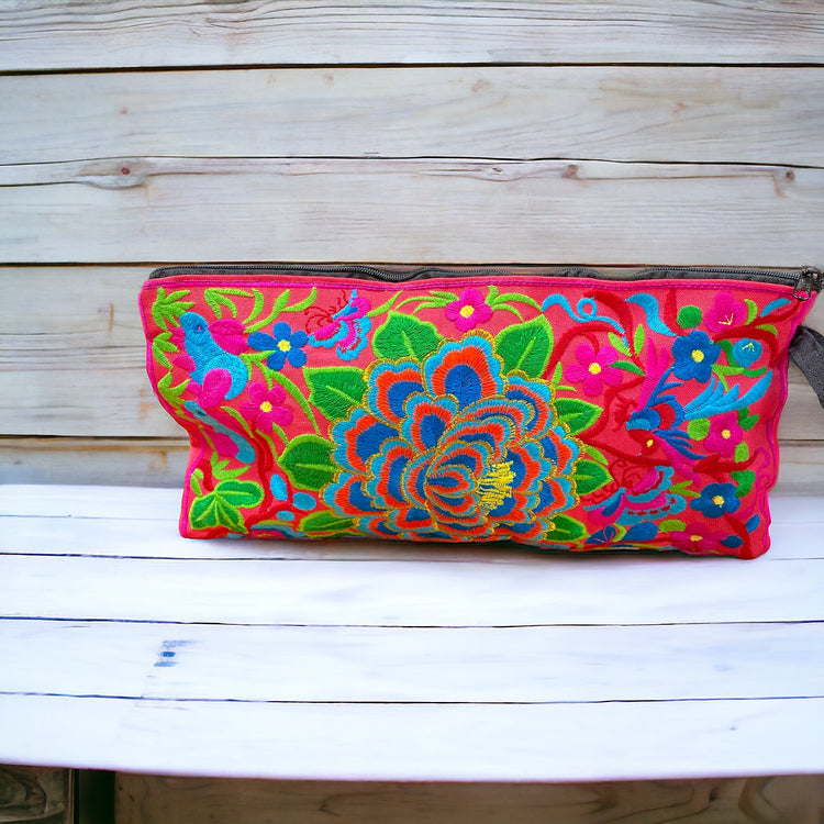 Aqua and tangerine blossom on pink clutch