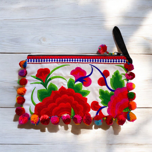 Cherry red blossom on white with multi-coloured pom pom clutch