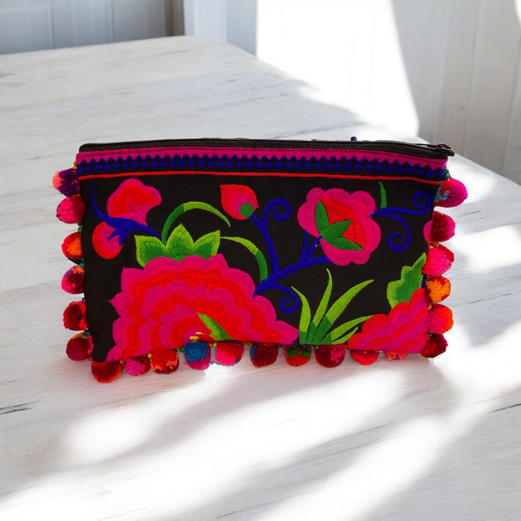 Hot pink and cherry red blossom on licorice with multi-coloured pom pom clutch