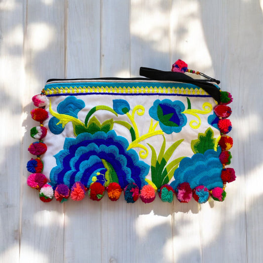 Teal and aqua blossom on white with multi-coloured pom pom clutch