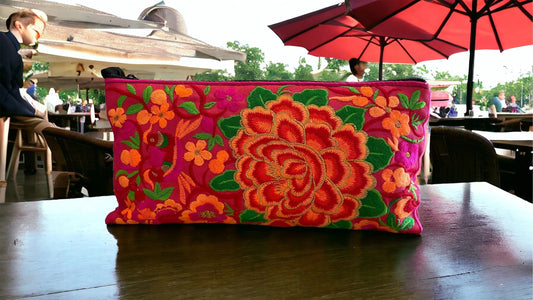 Tangerine bloom on rose pink clutch