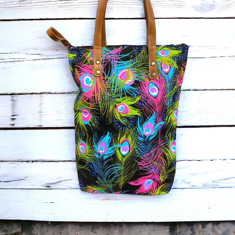 Neon peacock feathers on licorice midi tote