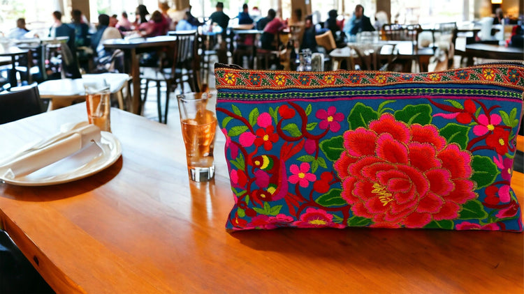 Scarlet and pink bloom on marine blue clutch