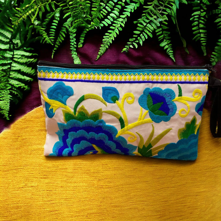 Aquamarine and cobalt blue bloom on white blue clutch