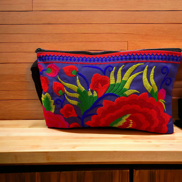 Ruby red bloom on electric blue clutch